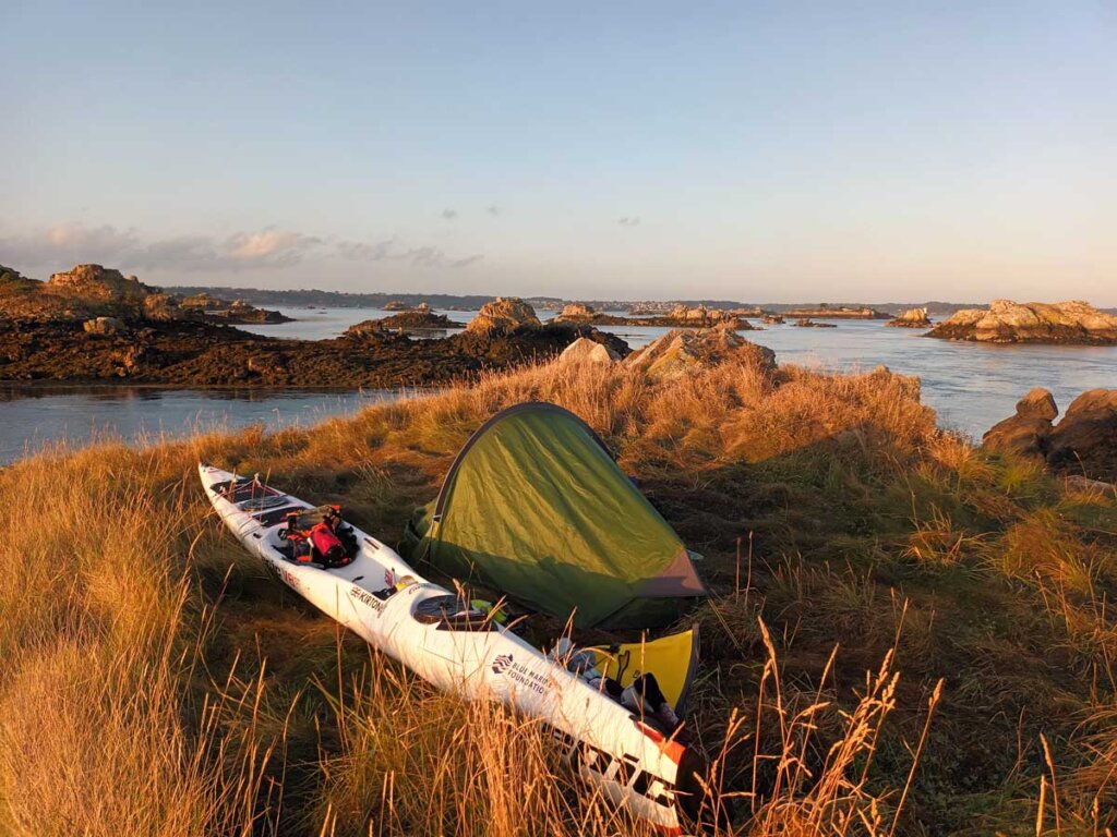 tent on kayak expedition in sunset